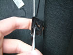 Slacken the cord by adjusting the ratchet